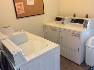 two washers and two dryers in a laundry room